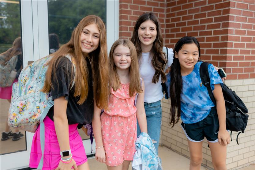 A group of students smiles